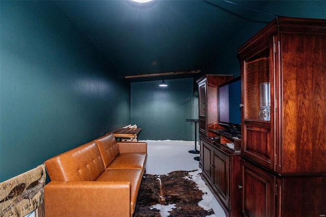 living area with lofted ceiling and baseboards