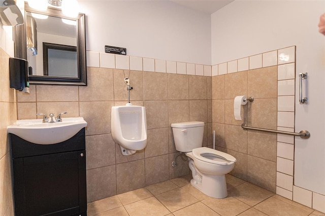 bathroom with toilet, tile walls, tile patterned floors, and vanity