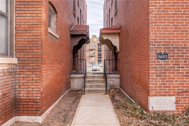 view of exterior entry featuring brick siding