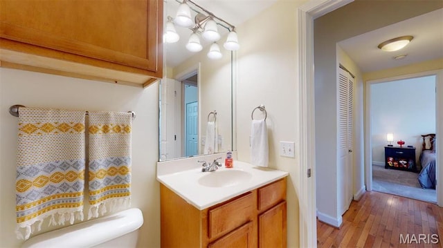5653 Waterman Blvd Unit 1N, Saint Louis, MO 63112 - bathroom featuring hardwood / wood-style flooring, vanity, and toilet