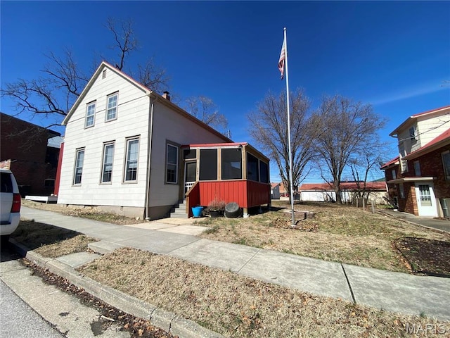209 E 3rd St, Hermann, MO 65041 - view of front of property with a sunroom, entry steps, a chimney, and crawl space