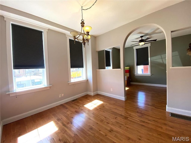 209 E 3rd St, Hermann, MO 65041 - unfurnished room featuring wood finished floors, ceiling fan, a chandelier, and baseboards