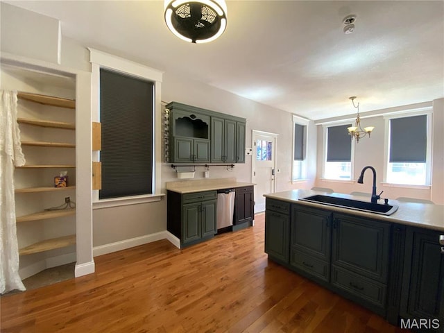 209 E 3rd St, Hermann, MO 65041 - kitchen featuring a sink, stainless steel dishwasher, wood finished floors, a chandelier, and light countertops