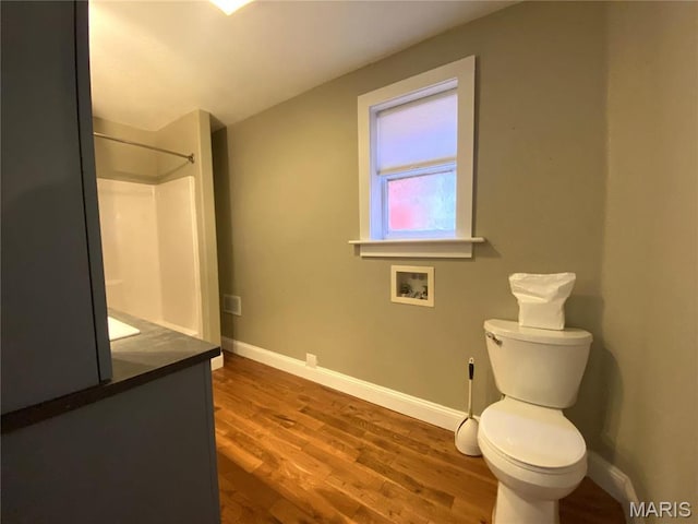 209 E 3rd St, Hermann, MO 65041 - full bath with baseboards, toilet, wood finished floors, a shower, and vanity