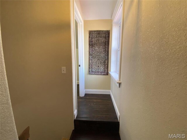 209 E 3rd St, Hermann, MO 65041 - hallway featuring baseboards, dark wood finished floors, and a textured wall