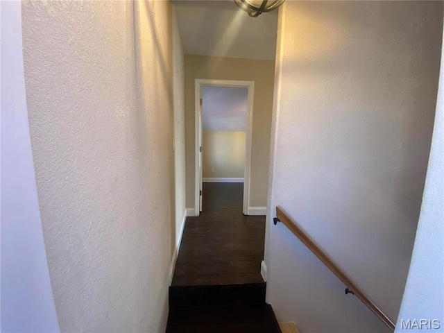 209 E 3rd St, Hermann, MO 65041 - staircase with a textured wall, wood finished floors, and baseboards