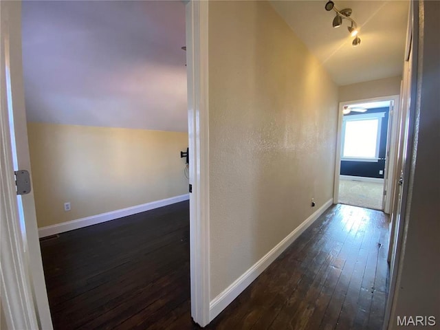 209 E 3rd St, Hermann, MO 65041 - corridor featuring dark wood-style flooring, lofted ceiling, and baseboards