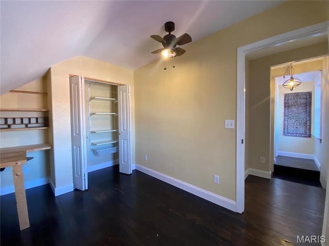 209 E 3rd St, Hermann, MO 65041 - unfurnished bedroom featuring dark wood-type flooring, lofted ceiling, a closet, baseboards, and ceiling fan
