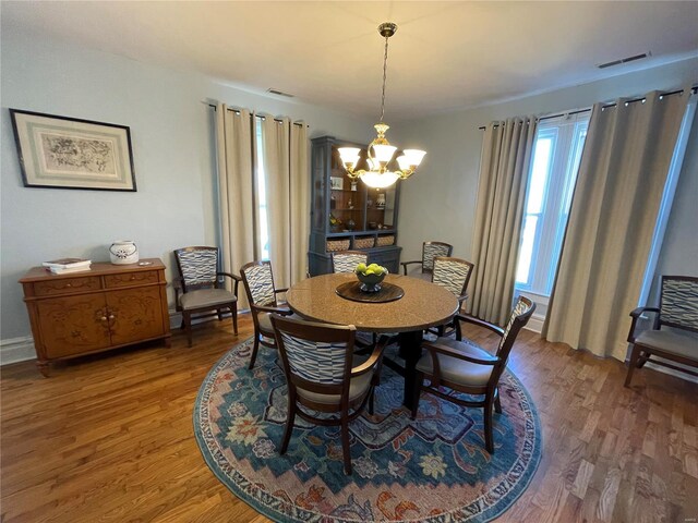 506 E Jefferson St, Perry, MO 63462 - dining space featuring a chandelier, light wood finished floors, and baseboards
