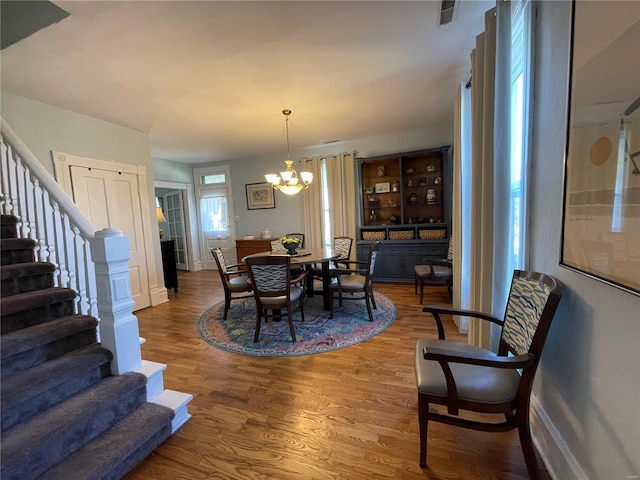 506 E Jefferson St, Perry, MO 63462 - dining room featuring wood finished floors, stairs, a chandelier, and baseboards