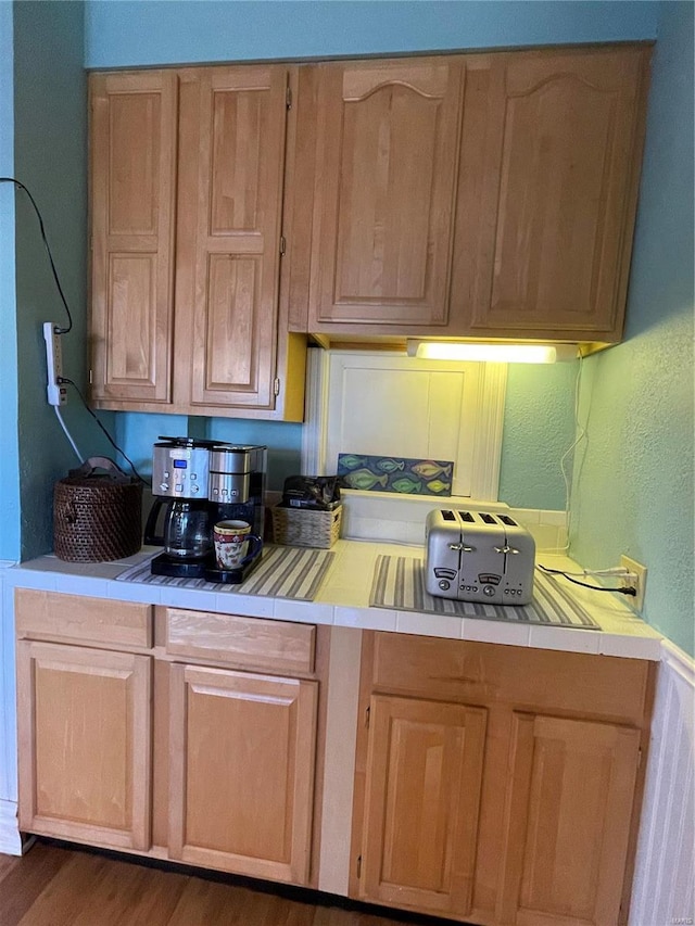 506 E Jefferson St, Perry, MO 63462 - kitchen with tile counters, wood finished floors, and light brown cabinets