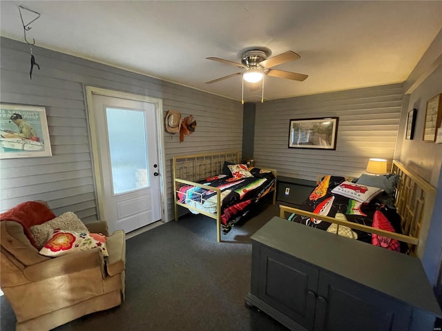 506 E Jefferson St, Perry, MO 63462 - bedroom featuring carpet flooring, a ceiling fan, and wooden walls