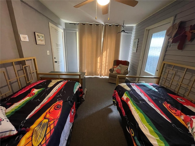 506 E Jefferson St, Perry, MO 63462 - bedroom featuring carpet flooring, ceiling fan, and wood walls