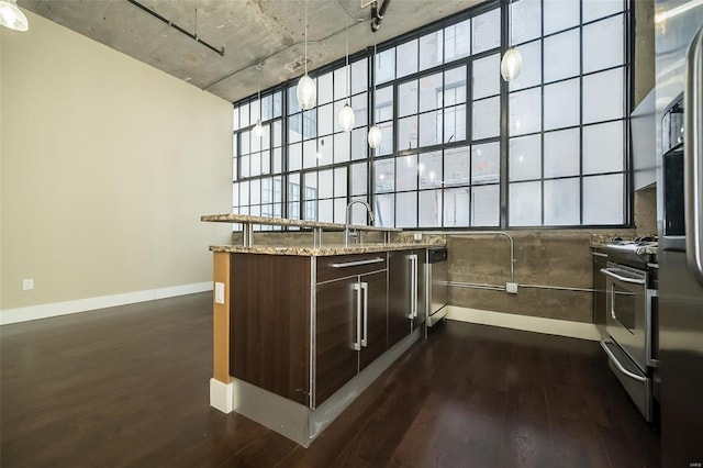 4100 Forest Park Ave Unit 226, Saint Louis, MO 63108 - bar with stainless steel appliances, dark wood finished floors, and baseboards