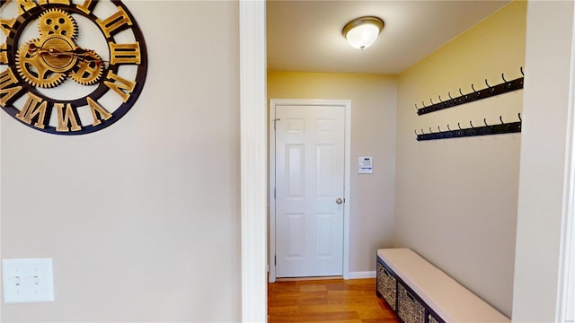 mudroom featuring light wood finished floors and baseboards