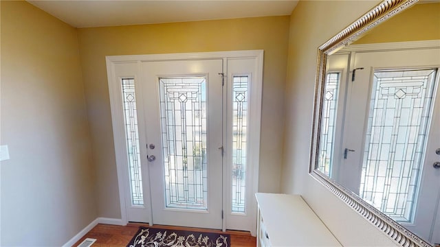 entrance foyer featuring plenty of natural light, wood finished floors, and baseboards