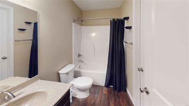 bathroom featuring wood finished floors, vanity, toilet, and shower / bath combo