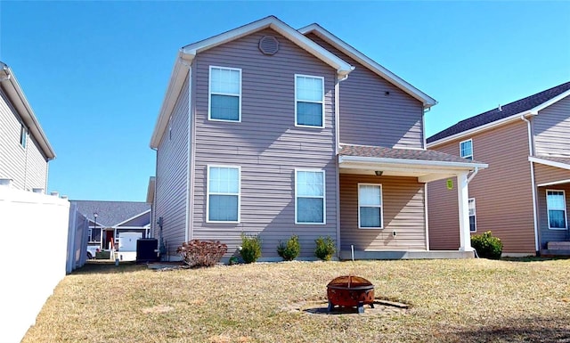 back of property with a fire pit