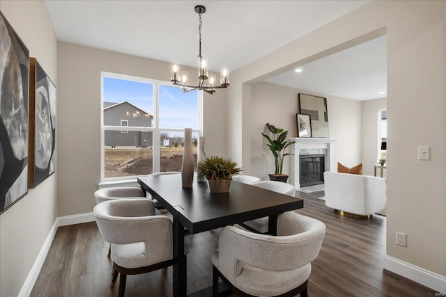 513 Beneficial Way, Saint Charles, MO 63304 - dining space featuring a chandelier, baseboards, a glass covered fireplace, dark wood finished floors, and recessed lighting