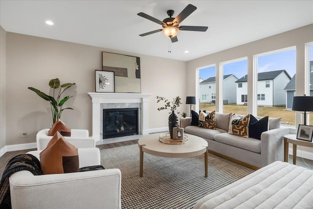 513 Beneficial Way, Saint Charles, MO 63304 - living room featuring baseboards, wood finished floors, ceiling fan, a premium fireplace, and recessed lighting