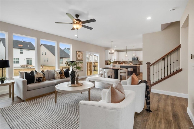 513 Beneficial Way, Saint Charles, MO 63304 - living room featuring dark wood-type flooring, ceiling fan, baseboards, stairway, and recessed lighting