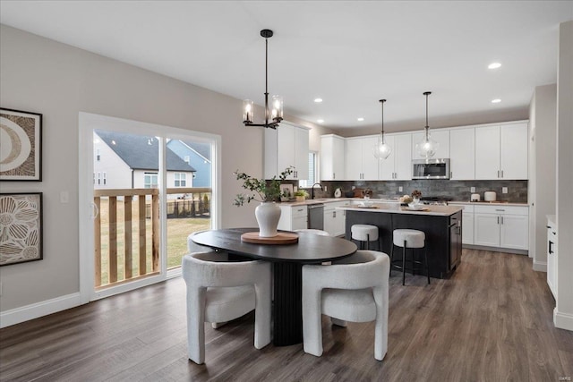 513 Beneficial Way, Saint Charles, MO 63304 - dining room featuring dark wood finished floors, a chandelier, baseboards, and recessed lighting