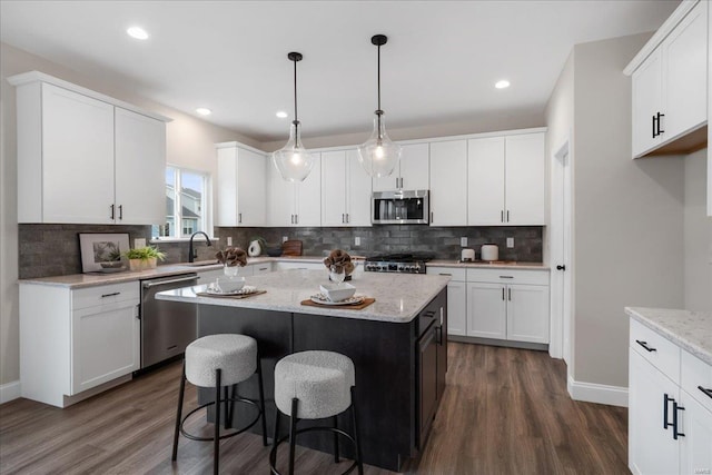 513 Beneficial Way, Saint Charles, MO 63304 - kitchen with appliances with stainless steel finishes, dark wood finished floors, white cabinets, and recessed lighting