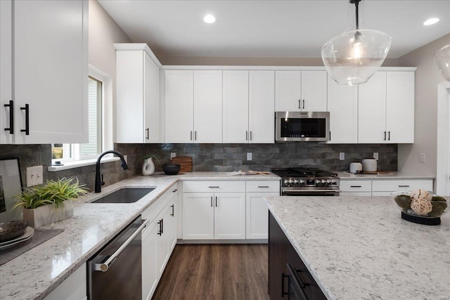 513 Beneficial Way, Saint Charles, MO 63304 - kitchen with stainless steel appliances, a sink, light stone counters, white cabinets, and recessed lighting