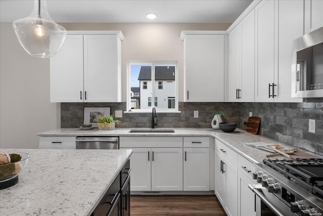 513 Beneficial Way, Saint Charles, MO 63304 - kitchen with a sink, stainless steel appliances, backsplash, white cabinetry, and recessed lighting