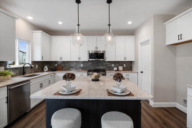 513 Beneficial Way, Saint Charles, MO 63304 - kitchen featuring stainless steel appliances, a sink, dark wood finished floors, decorative backsplash, and recessed lighting