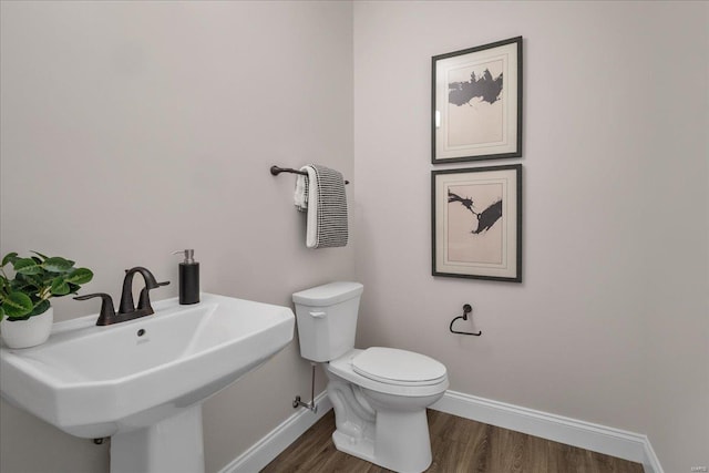 513 Beneficial Way, Saint Charles, MO 63304 - half bath with baseboards, wood finished floors, toilet, and a sink