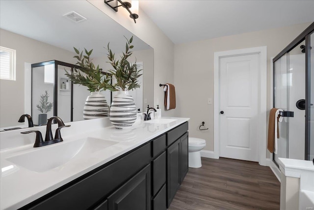 513 Beneficial Way, Saint Charles, MO 63304 - bathroom featuring a stall shower, wood finished floors, double vanity, and toilet