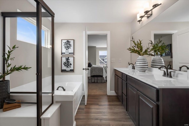 513 Beneficial Way, Saint Charles, MO 63304 - ensuite bathroom featuring wood finished floors, a garden tub, and double vanity