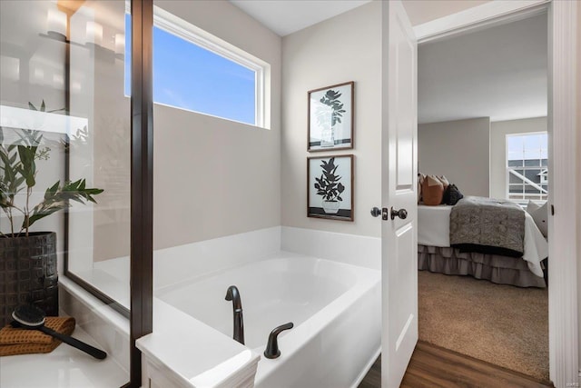 513 Beneficial Way, Saint Charles, MO 63304 - ensuite bathroom with a bath and wood finished floors