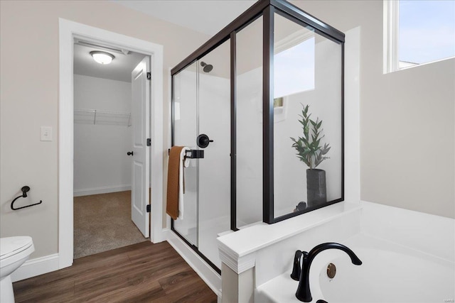 513 Beneficial Way, Saint Charles, MO 63304 - bathroom with a stall shower, toilet, wood finished floors, and a spacious closet