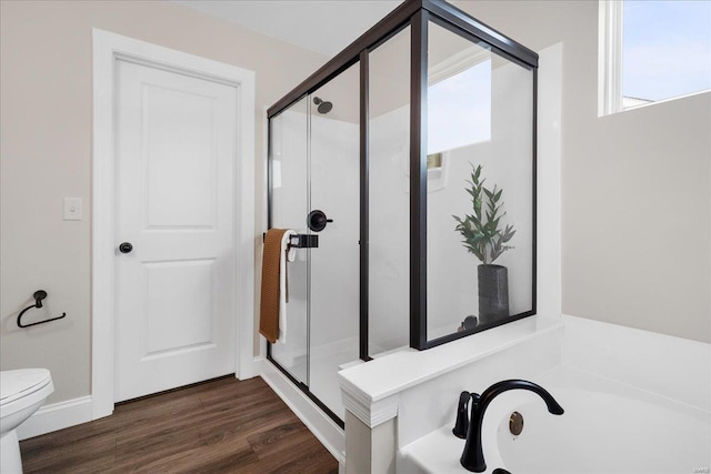 513 Beneficial Way, Saint Charles, MO 63304 - bathroom featuring a stall shower, toilet, wood finished floors, and a bath