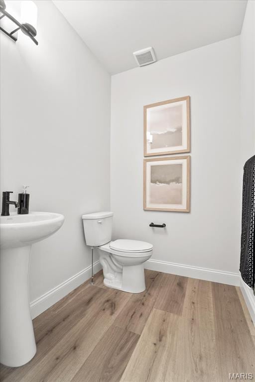 513 Beneficial Way, Saint Charles, MO 63304 - half bath with toilet, wood finished floors, baseboards, and a sink