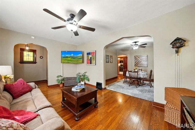 4355 Toenges Ave, Saint Louis, MO 63116 - living area with arched walkways, a ceiling fan, wood-type flooring, and baseboards