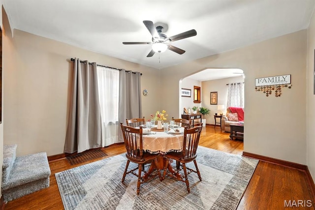 4355 Toenges Ave, Saint Louis, MO 63116 - dining space featuring arched walkways, ceiling fan, baseboards, and wood finished floors