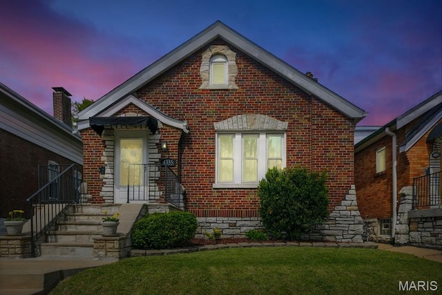 4355 Toenges Ave, Saint Louis, MO 63116 - view of front of home with brick siding and a yard
