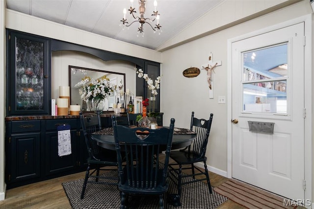 2 S Circle Dr, Carlyle, IL 62231 - dining space with a chandelier, lofted ceiling, wood finished floors, crown molding, and baseboards