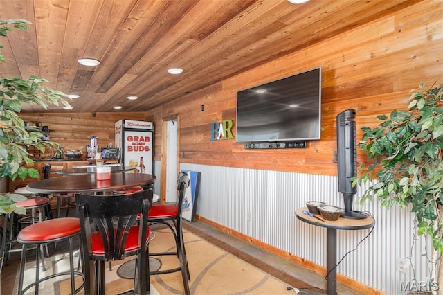 2 S Circle Dr, Carlyle, IL 62231 - dining room with wooden walls, recessed lighting, wood ceiling, baseboards, and concrete floors