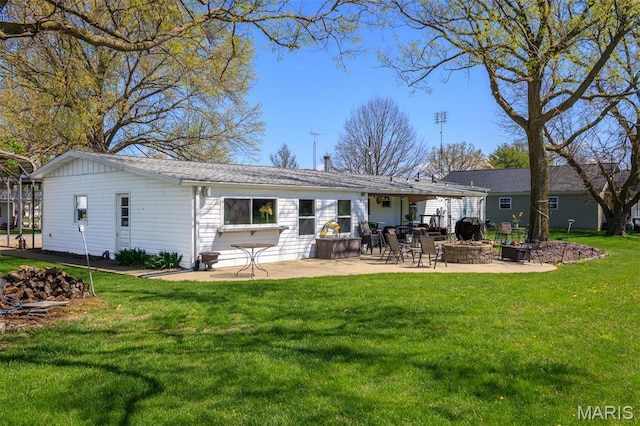 2 S Circle Dr, Carlyle, IL 62231 - back of property with a patio, an outdoor fire pit, and a yard