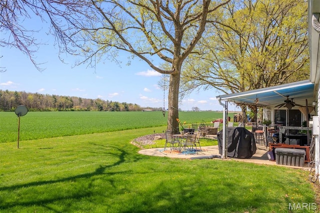 2 S Circle Dr, Carlyle, IL 62231 - view of grassy yard featuring a patio area, ceiling fan, and a view of rural / pastoral area