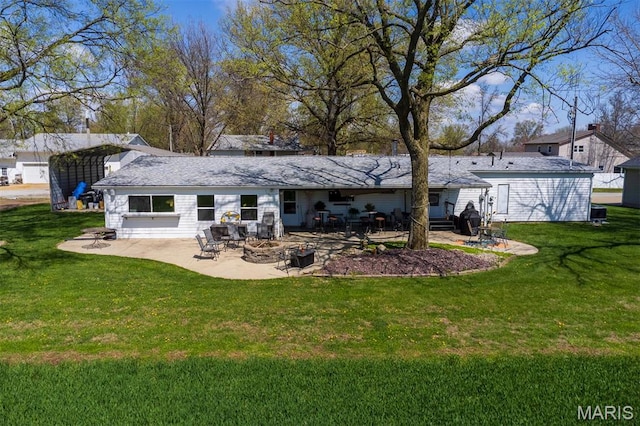 2 S Circle Dr, Carlyle, IL 62231 - rear view of house featuring a patio, a yard, and a fire pit