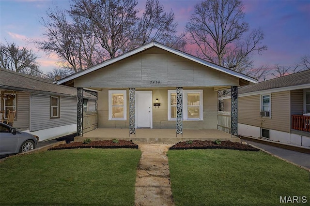 2430 Wallis Ave, Saint Louis, MO 63114 - view of front of house featuring covered porch, a front lawn, and cooling unit