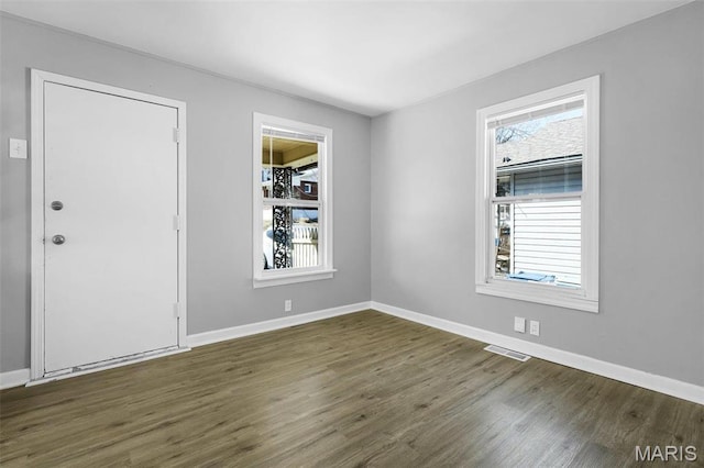 2430 Wallis Ave, Saint Louis, MO 63114 - empty room with dark wood-style floors and baseboards