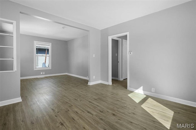 2430 Wallis Ave, Saint Louis, MO 63114 - empty room featuring baseboards and dark wood finished floors