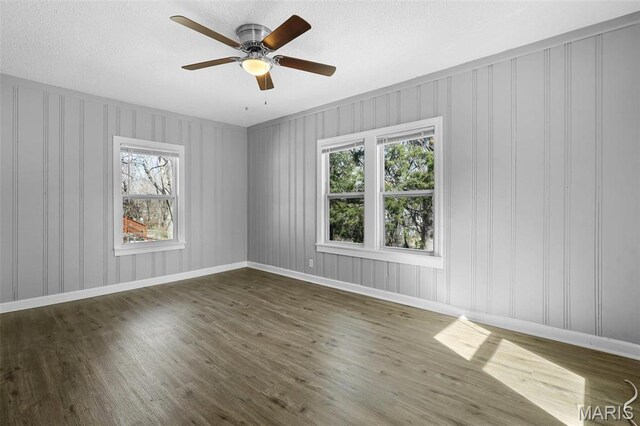 2430 Wallis Ave, Saint Louis, MO 63114 - spare room with wood finished floors, ceiling fan, baseboards, and a textured ceiling