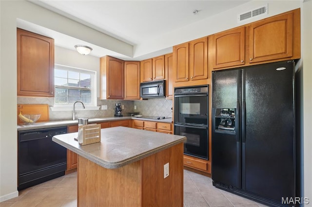 2 Monarch Trace Ct Unit 305, Chesterfield, MO 63017 - kitchen with black appliances, light tile patterned floors, backsplash, a center island, and a sink